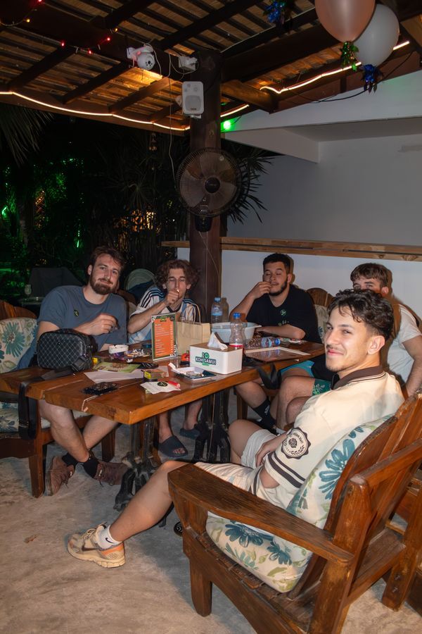 Guests dining at a wooden table inside MG Bistro, Ko Samui