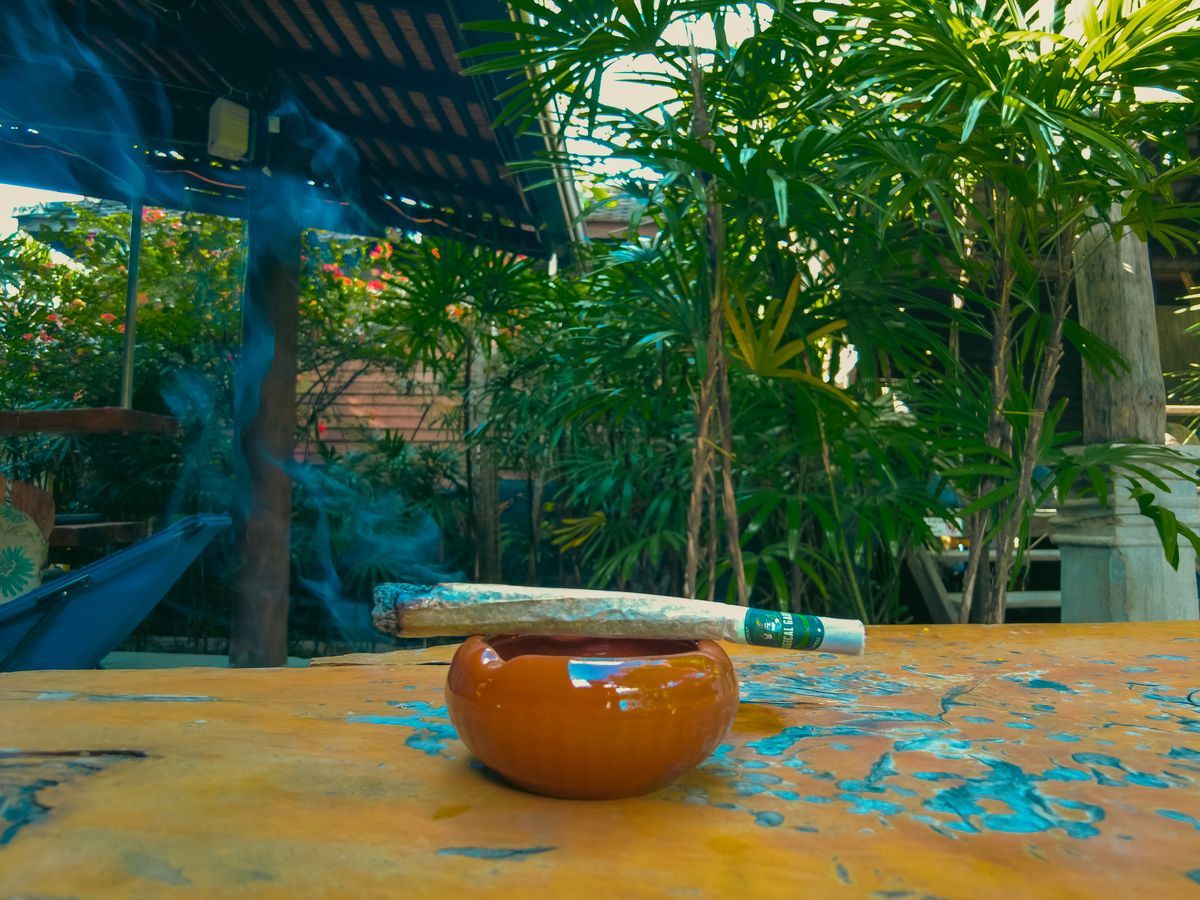 Cannabis joint being smoked at a lounge table in Magical Garden, Ko Samui