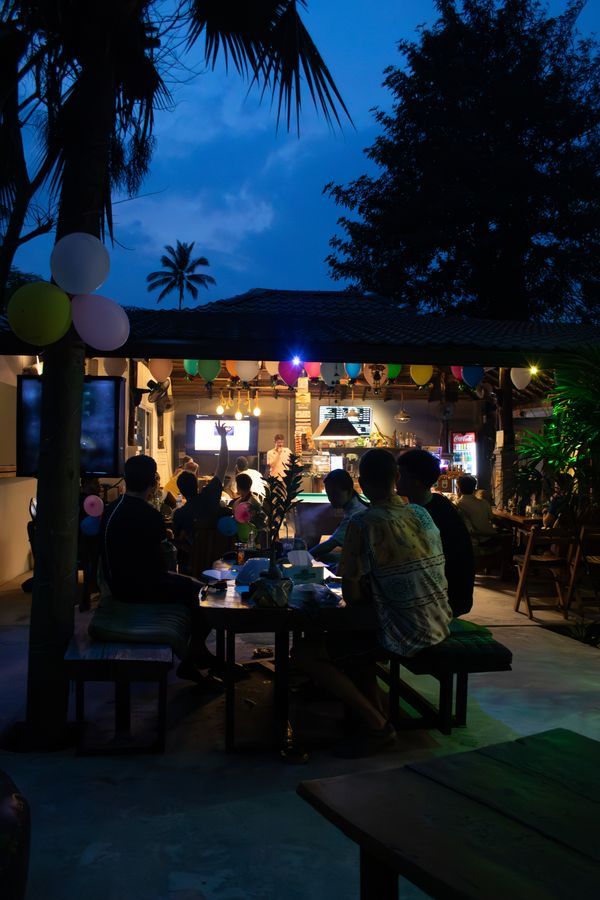 Evening dining gathering under the palms at MG Bistro, Ko Samui